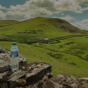 high-cup-nick-fell-with-bottle-of-aqua-pura-water-on-a-wall-to-the-left