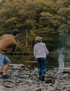 farther-and-son-having-fun-skimming-rocks-at-lowther-castle