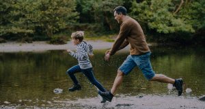 farther-and-son-running-through-puddles-in-the-lake-district