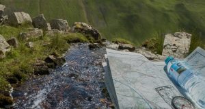 close-up-of-a-walking-map-and-a-bottle-of-aqua-pura-water