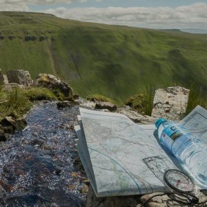 close-up-of-a-walking-map-and-a-bottle-of-aqua-pura-water