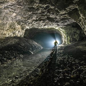 person-inside-a-dark-cave-with-light-shining-through