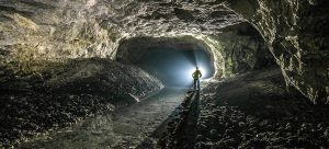 person-inside-a-dark-cave-with-light-shining-through